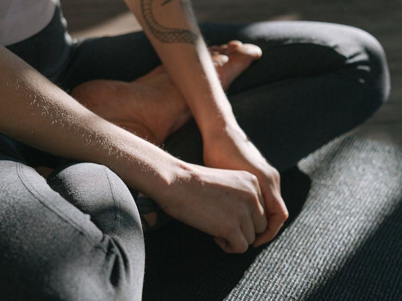 Close-up of a person's hands in a meditative pose.